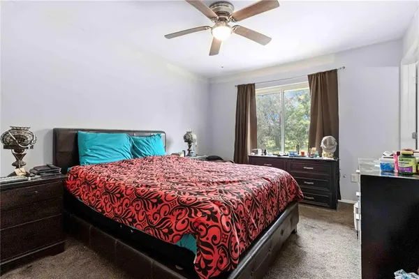 a bedroom with a bed and a window