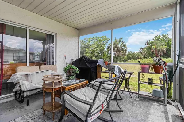 a dining room with furniture and a potted plant