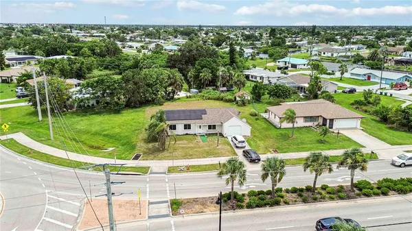 an aerial view of residential houses with outdoor space and street view
