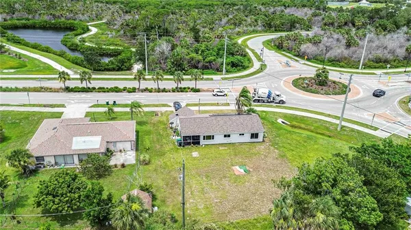 an aerial view of a house with swimming pool and green space