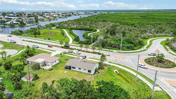 an aerial view of residential houses with outdoor space and street view