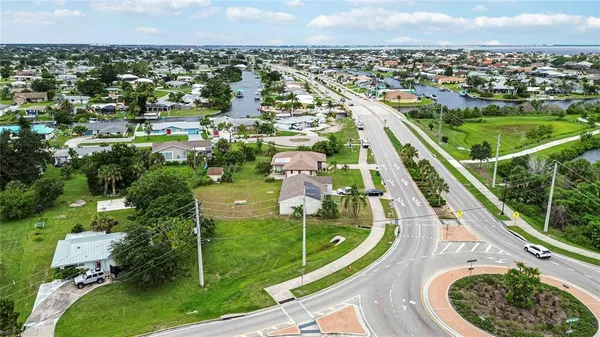 an aerial view of residential houses with outdoor space and river