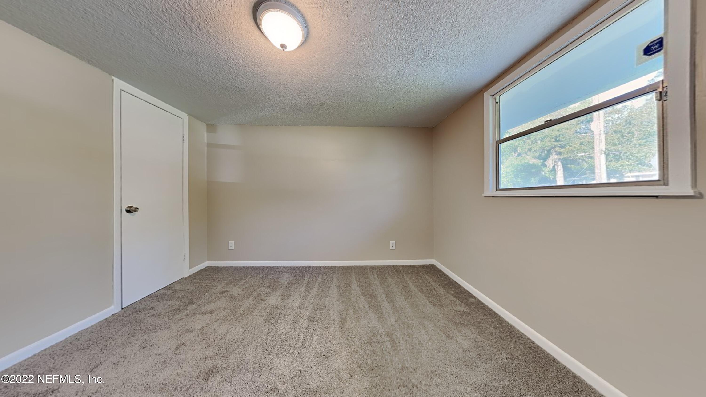 10729 Tulsa Road Jacksonville, FL 32218 - Photo 12 of 21 an empty room with a window
