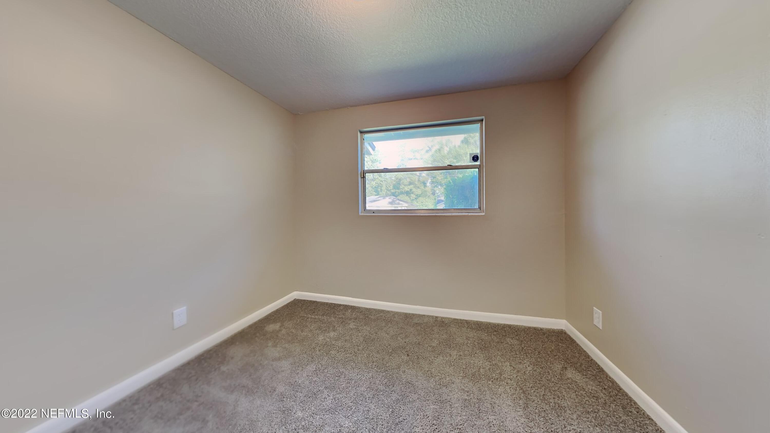 10729 Tulsa Road Jacksonville, FL 32218 - Photo 14 of 21 an empty room with a window