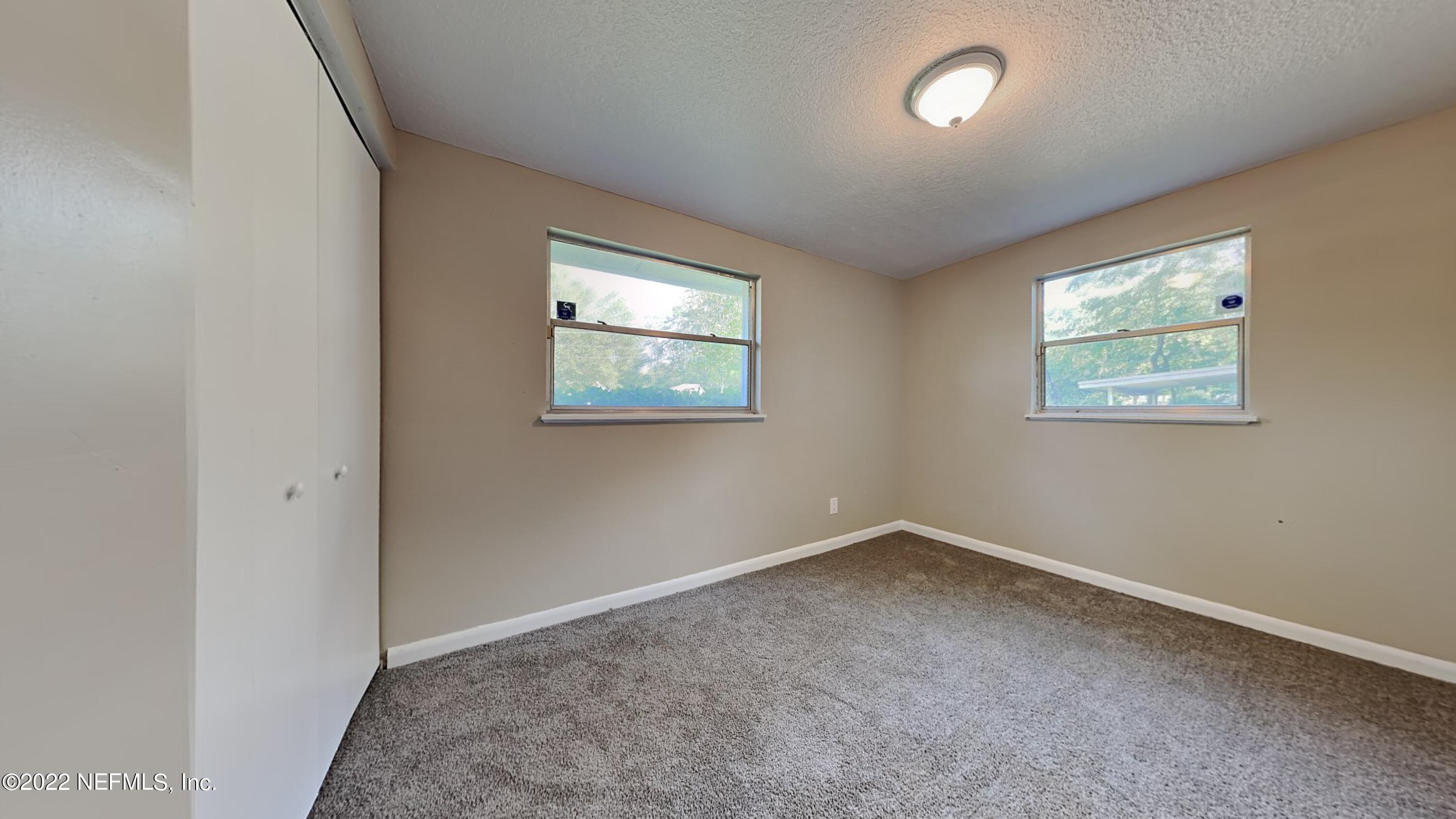 10729 Tulsa Road Jacksonville, FL 32218 - Photo 15 of 21 an empty room with windows