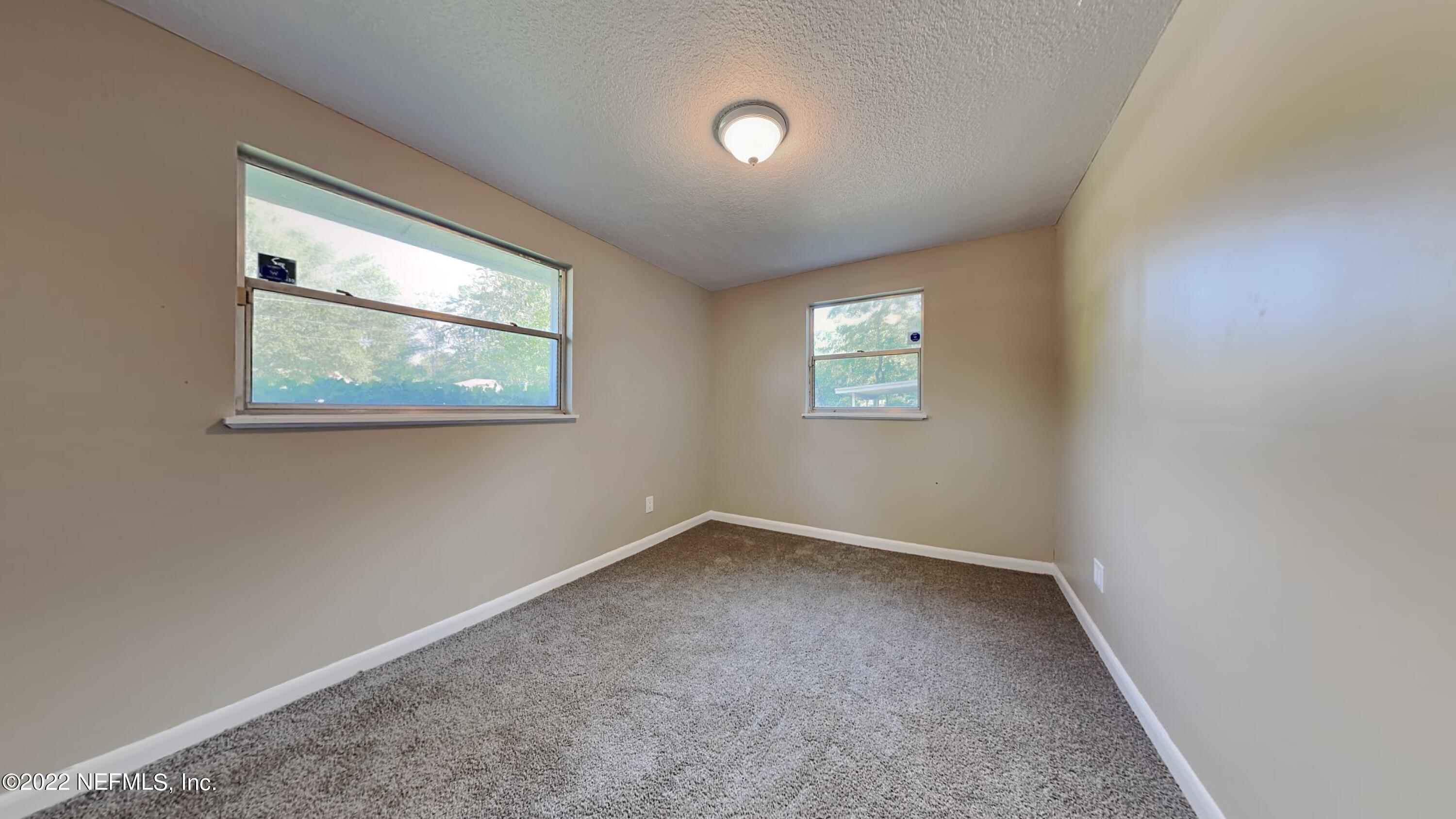10729 Tulsa Road Jacksonville, FL 32218 - Photo 16 of 21 an empty room with windows