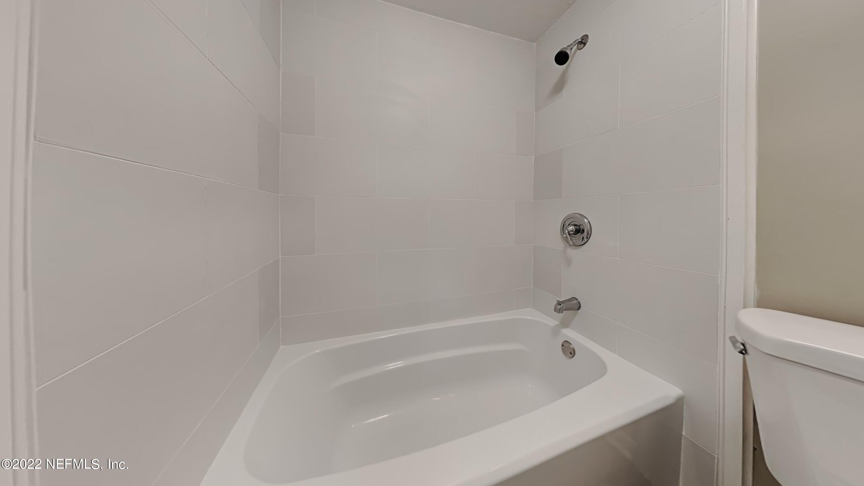 10729 Tulsa Road Jacksonville, FL 32218 - Photo 18 of 21 a white bath tub sitting next to a toilet