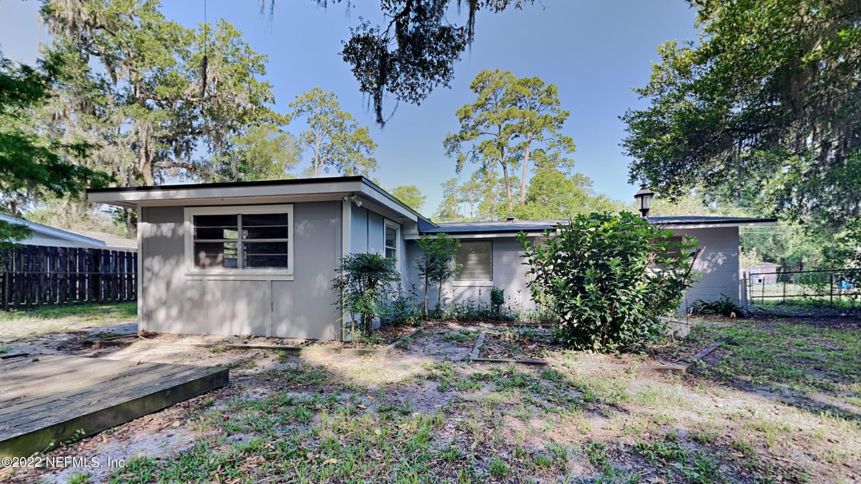 10729 Tulsa Road Jacksonville, FL 32218 - Photo 20 of 21 a view of a house with a yard and plants