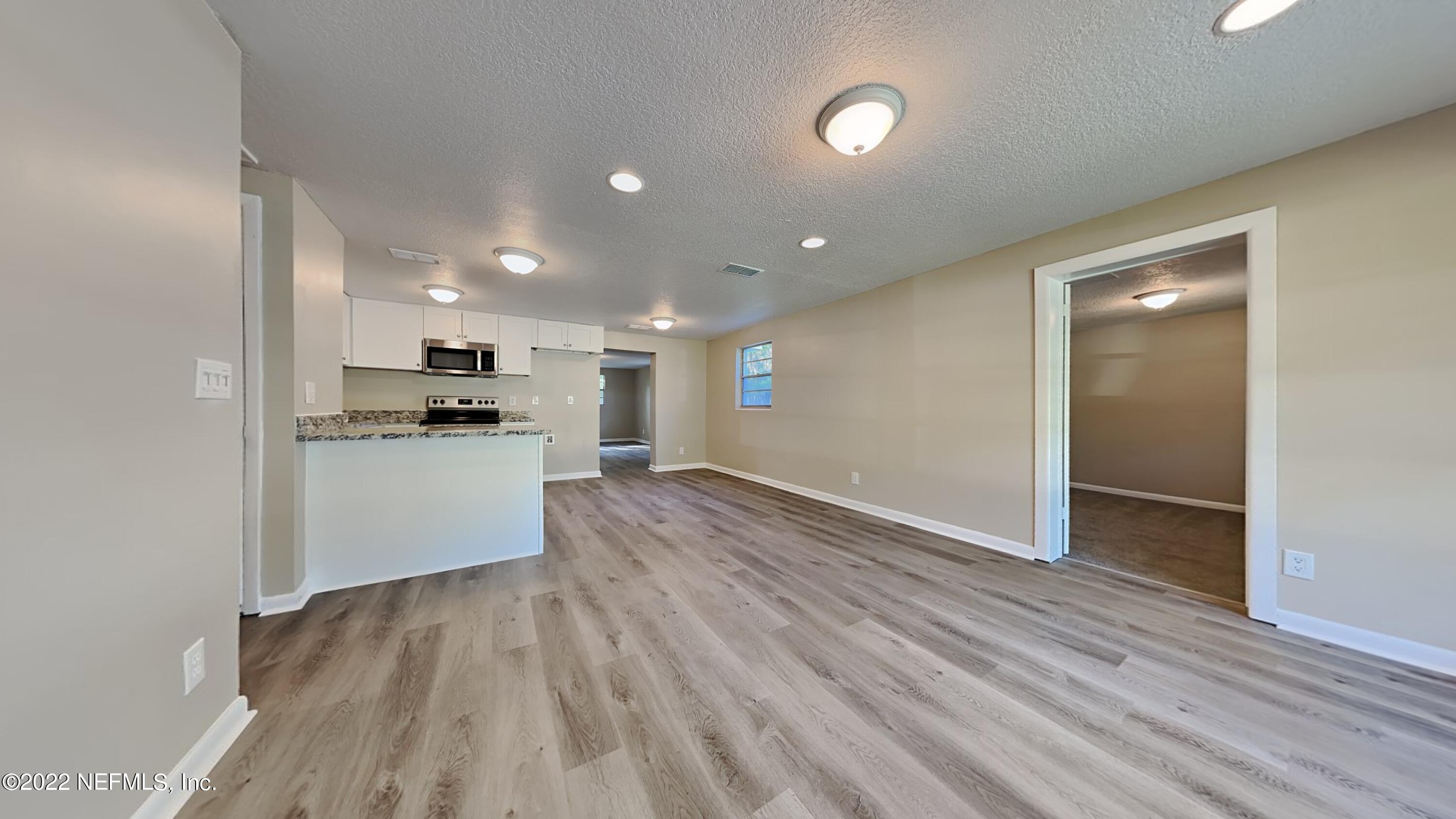 10729 Tulsa Road Jacksonville, FL 32218 - Photo 2 of 21 a view of kitchen view wooden floor and stainless steel appliances