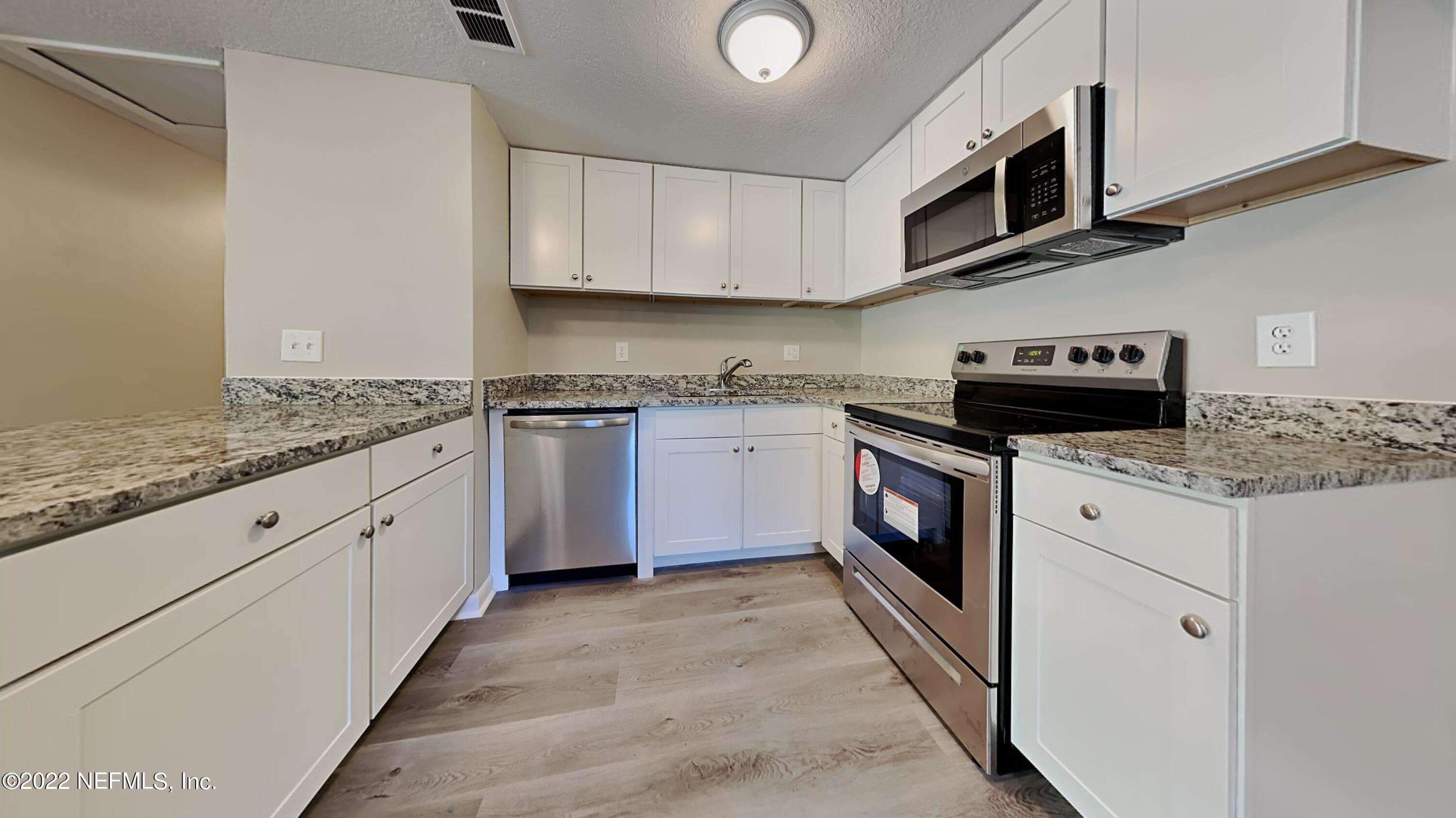 10729 Tulsa Road Jacksonville, FL 32218 - Photo 7 of 21 a kitchen with stainless steel appliances granite countertop a stove top oven a sink and dishwasher