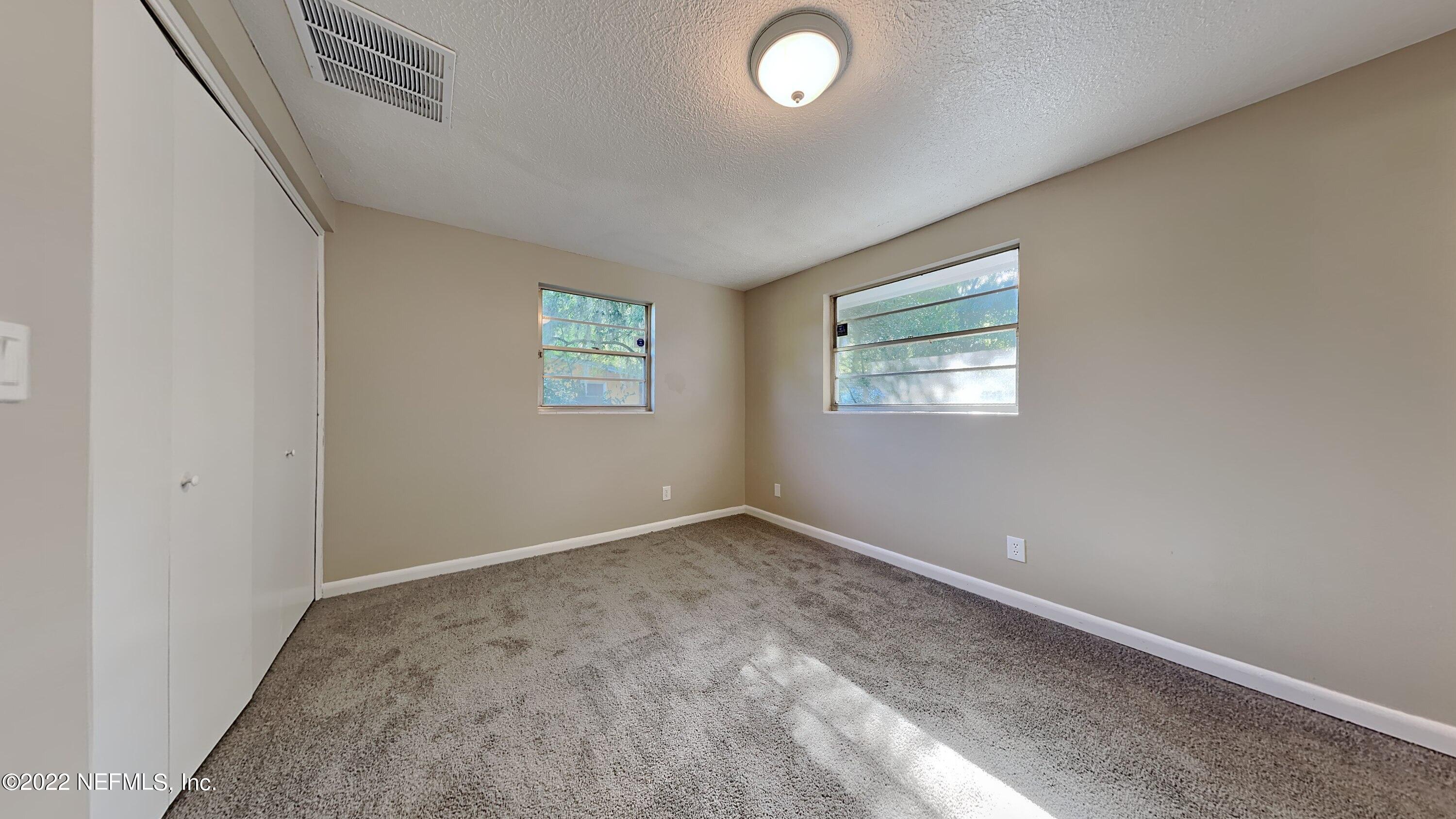 10729 Tulsa Road Jacksonville, FL 32218 - Photo 9 of 21 an empty room with windows