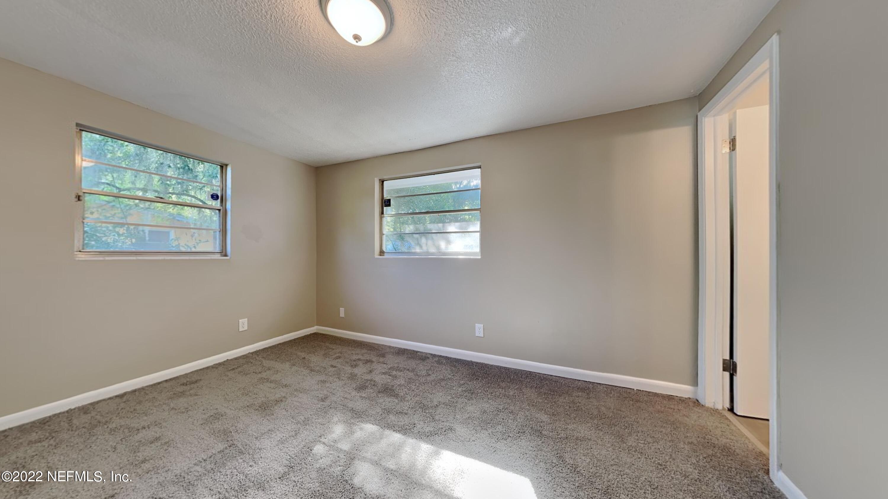 10729 Tulsa Road Jacksonville, FL 32218 - Photo 10 of 21 an empty room with windows