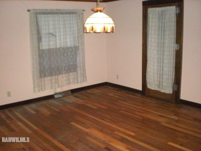 23929 Carroll Road Lanark, IL 61046 - Photo 8 of 25 a view of an empty room with wooden floor and a window
