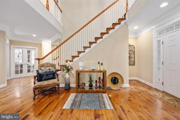 a kitchen that has a lot of cabinets in it and wooden floors