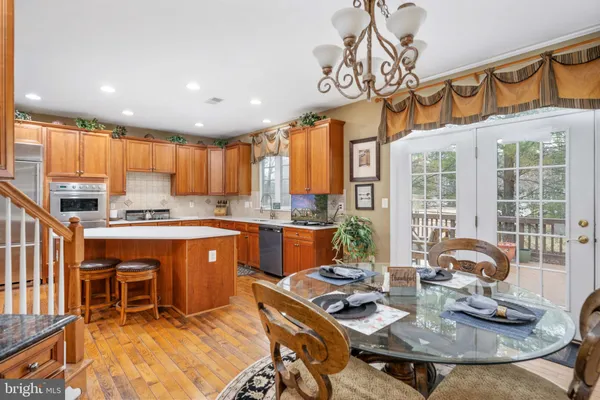 a front view of a house with a yard and trees