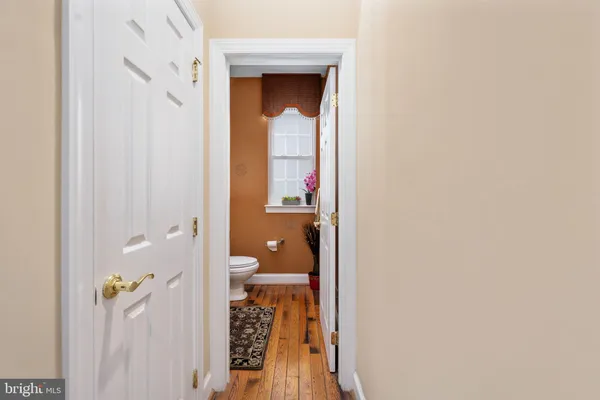 a view of a patio with table and chairs potted plants and floor to ceiling window and potted plants