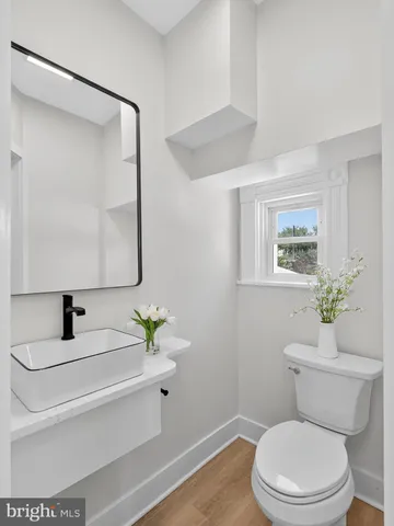 a bathroom with a sink toilet and mirror