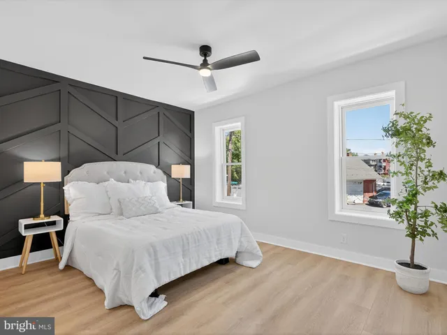 a bedroom with a bed and a potted plant