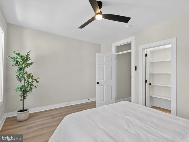 a bedroom with a bed and a potted plant