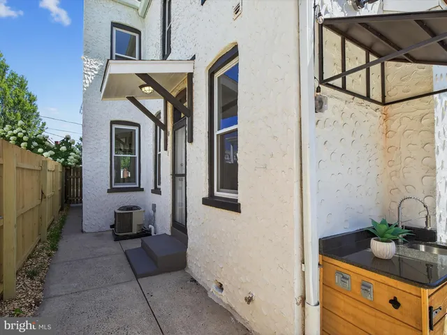 a bathroom with a granite countertop sink a mirror and shower