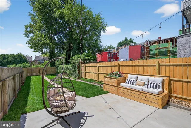 a view of a garden with a building in the background