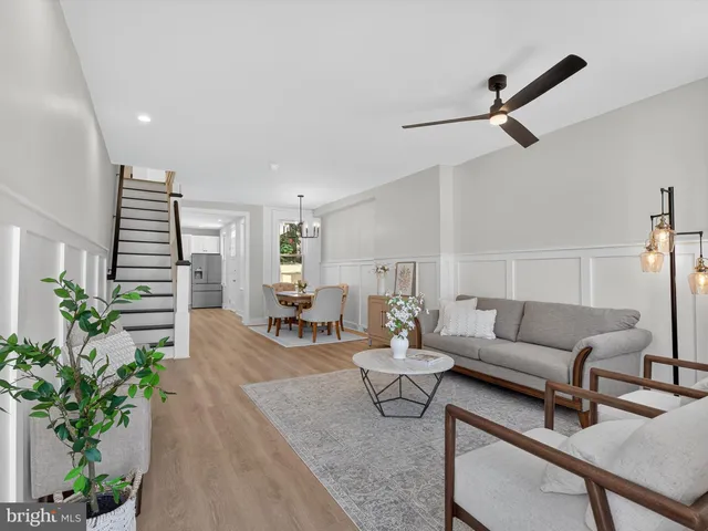 a living room with furniture and a potted plant