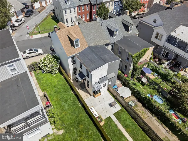 an aerial view of a house with a garden and swimming pool
