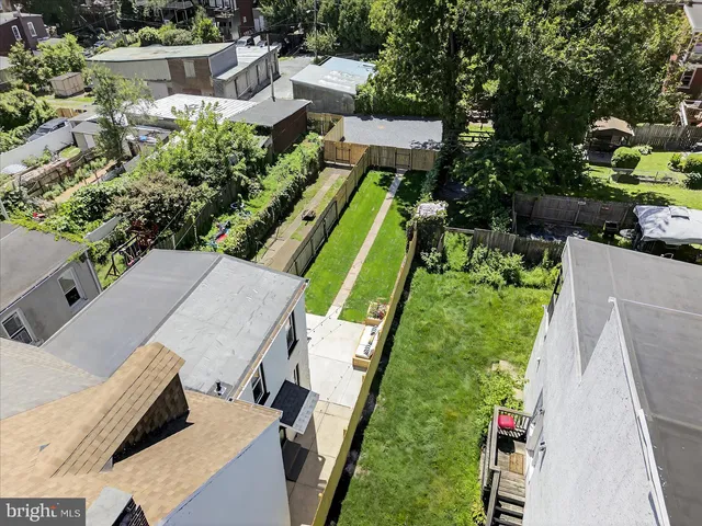 an aerial view of a house with a yard and lake view