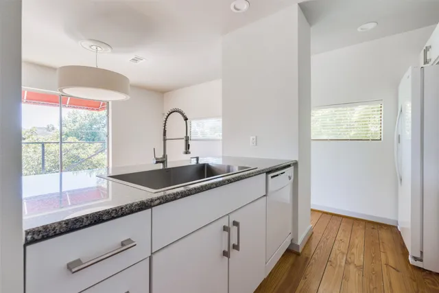 a kitchen with stainless steel appliances a refrigerator and a microwave