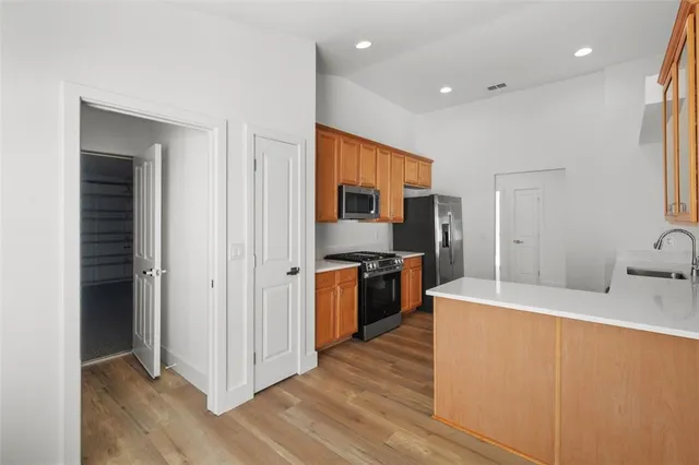 a large kitchen with a sink and a refrigerator