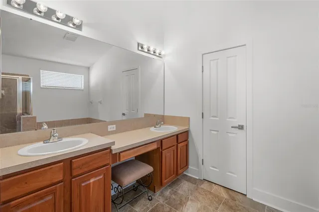 a bathroom with a sink a light fixture and a mirror