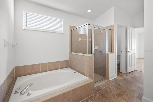 a bathroom with a tub and a shower