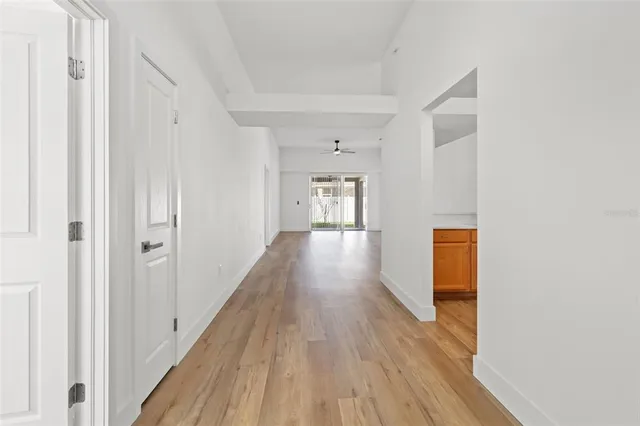 a view of a hallway with wooden floor