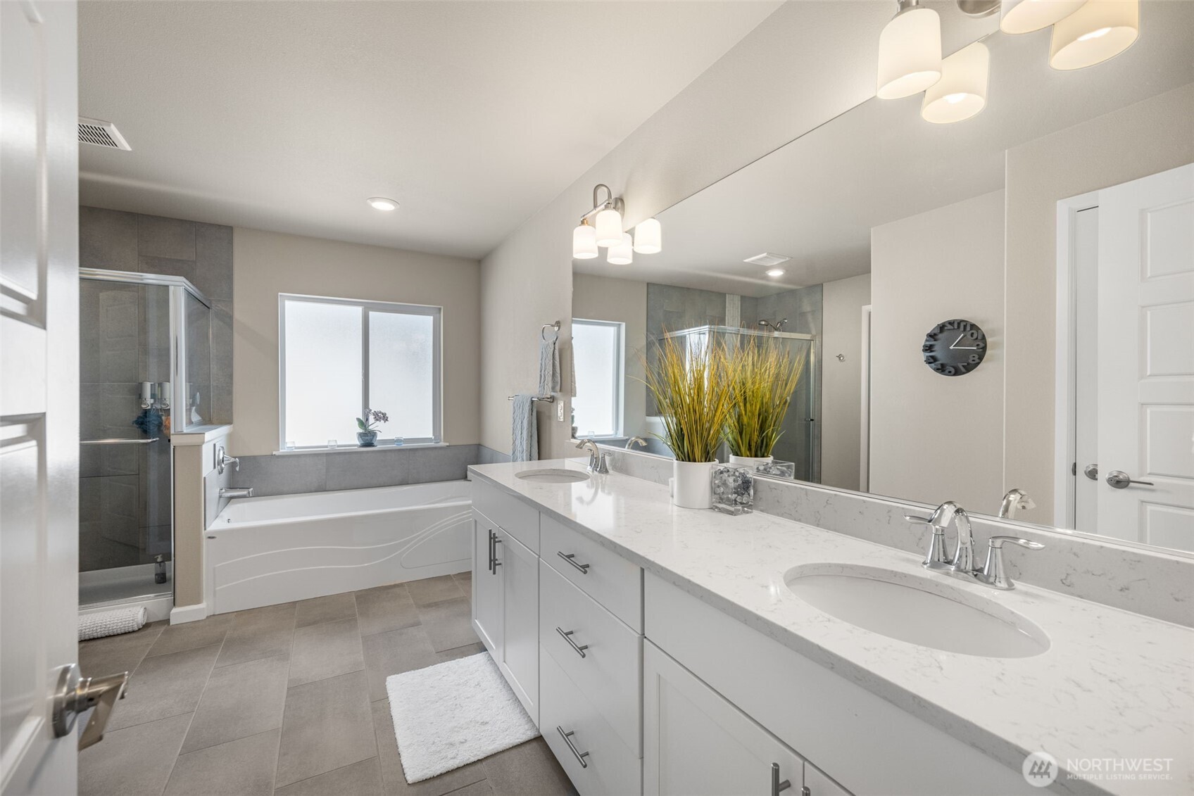 216 178th Street Southeast Bothell, WA 98012 - Photo 25 of 40 a bathroom with a sink double vanity granite tub shower and a mirror