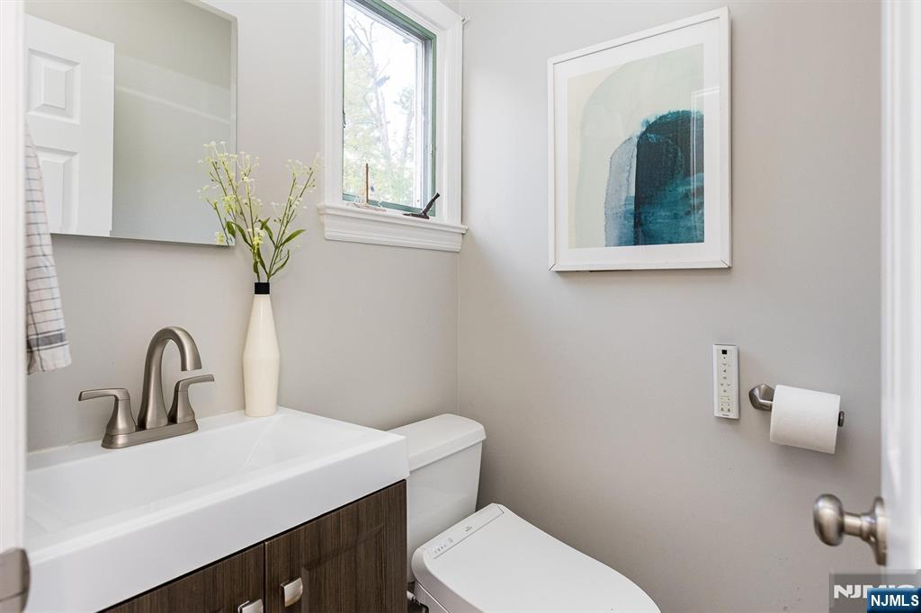 199 Stonehouse Road Bloomfield, NJ 07028 - Photo 17 of 36 a bathroom with a toilet sink and mirror