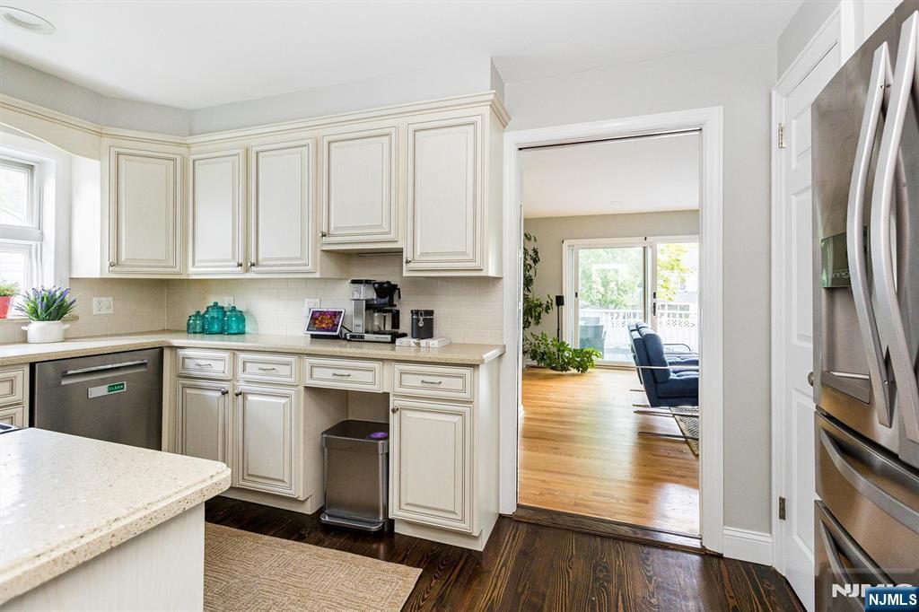 199 Stonehouse Road Bloomfield, NJ 07028 - Photo 18 of 36 a kitchen with white cabinets and white appliances