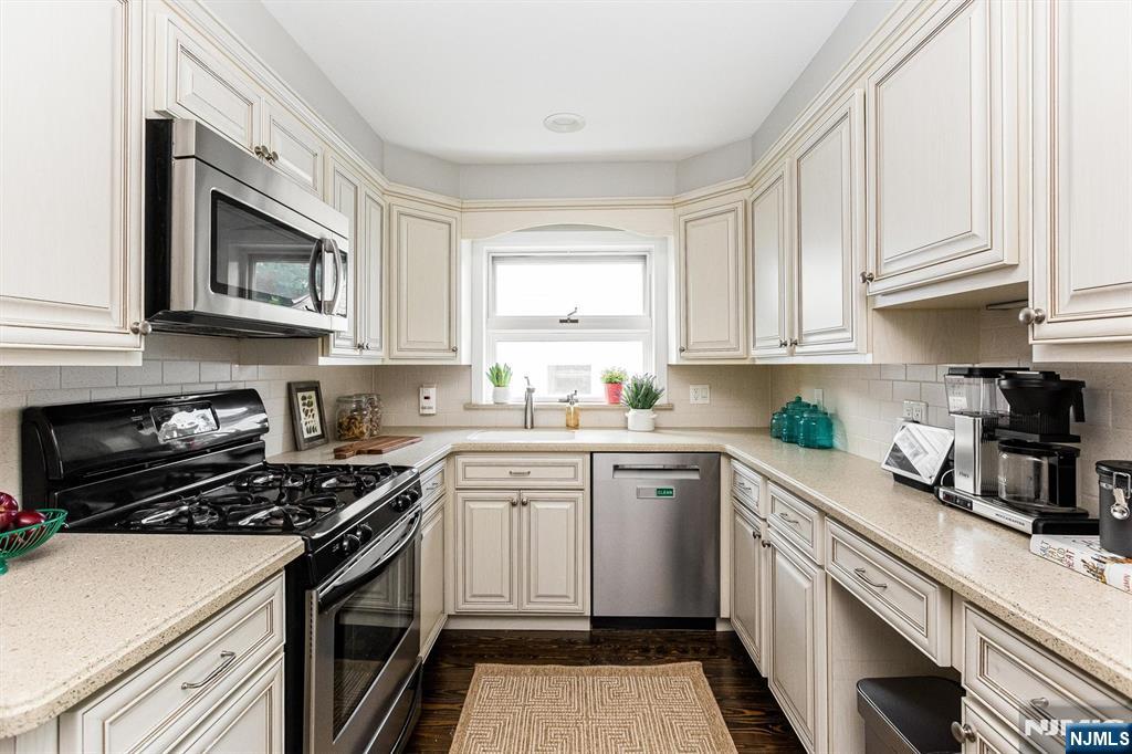 199 Stonehouse Road Bloomfield, NJ 07028 - Photo 19 of 36 a kitchen with stainless steel appliances granite countertop white cabinets a stove a sink and dishwasher