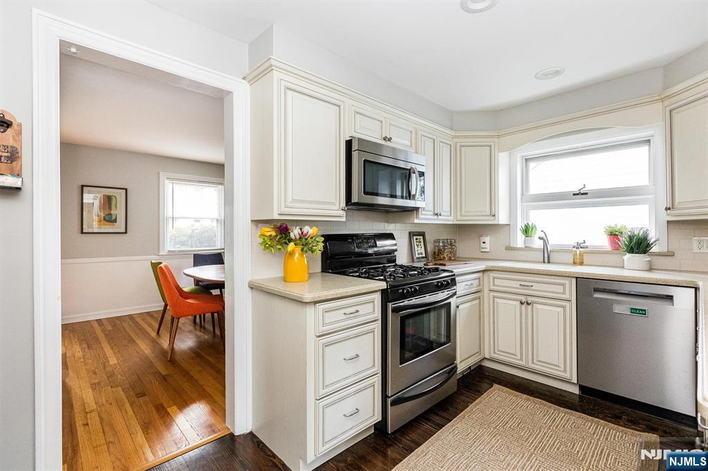199 Stonehouse Road Bloomfield, NJ 07028 - Photo 20 of 36 a kitchen with stainless steel appliances granite countertop a stove a sink and a microwave