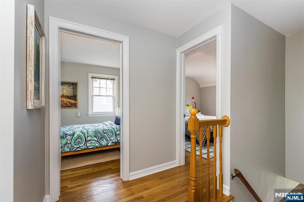 199 Stonehouse Road Bloomfield, NJ 07028 - Photo 23 of 36 a view of a hallway with wooden floor and a livingroom