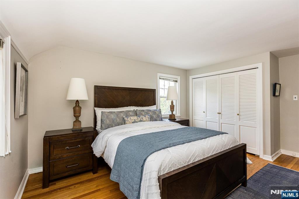 199 Stonehouse Road Bloomfield, NJ 07028 - Photo 25 of 36 a bedroom with a bed and a lamp