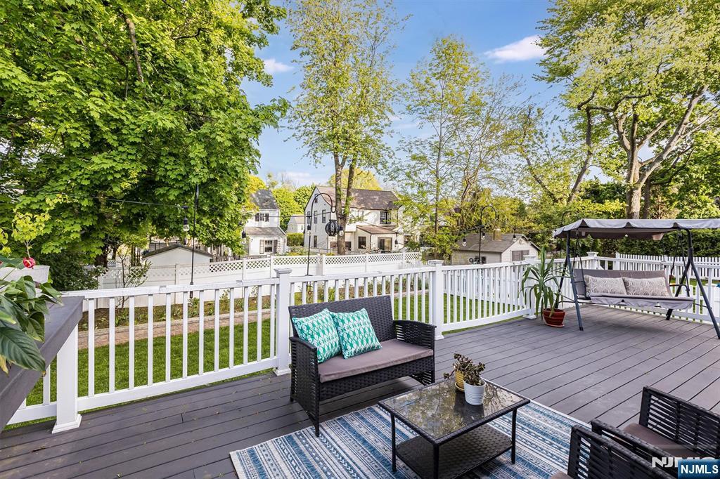 199 Stonehouse Road Bloomfield, NJ 07028 - Photo 32 of 36 a view of a deck with couches wooden floor and fence