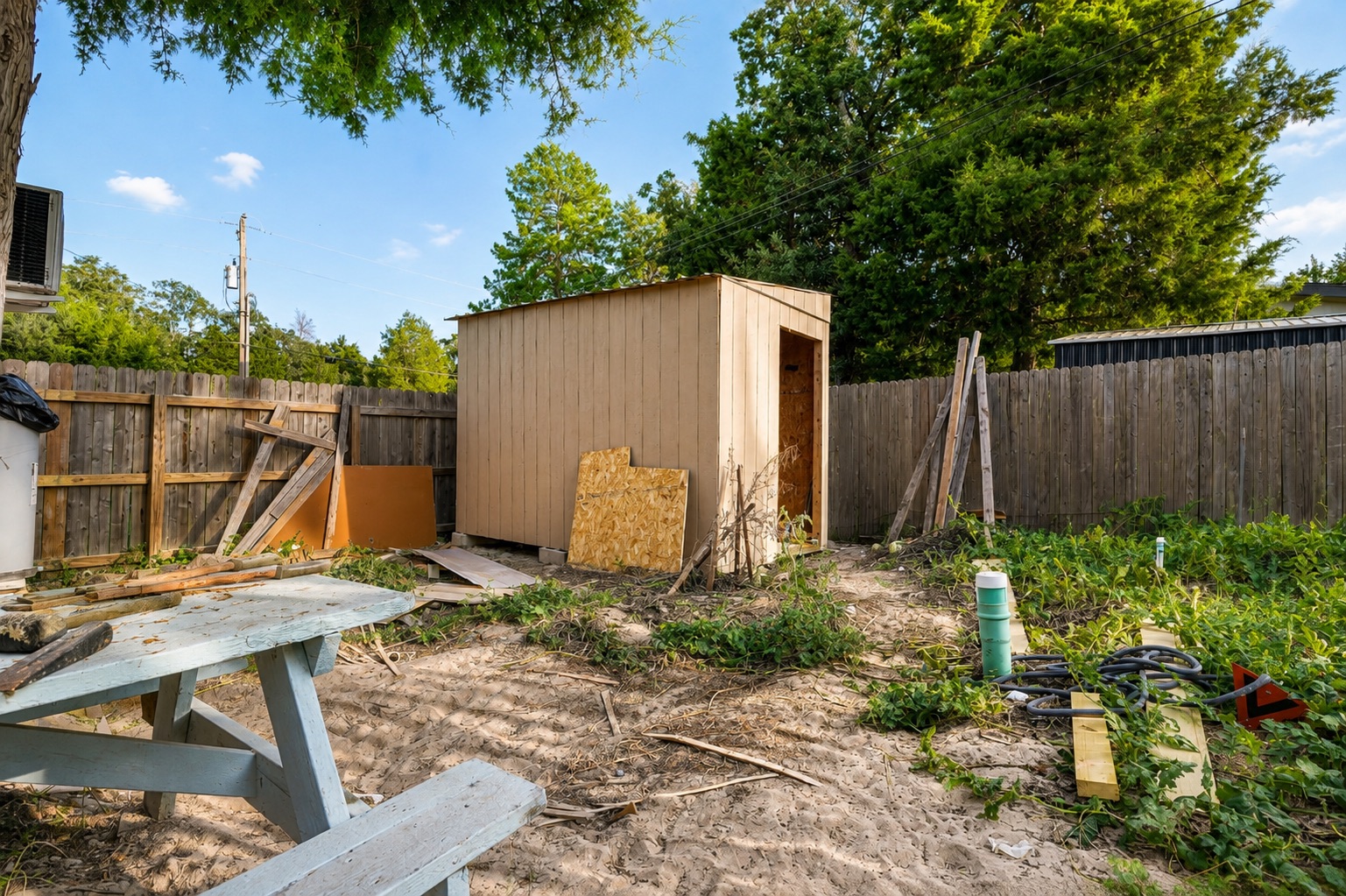 130 Los Arcos Road Elgin, TX 78621 - Photo 29 of 39 A private yard with a secure wooden fence and a practical storage shed.