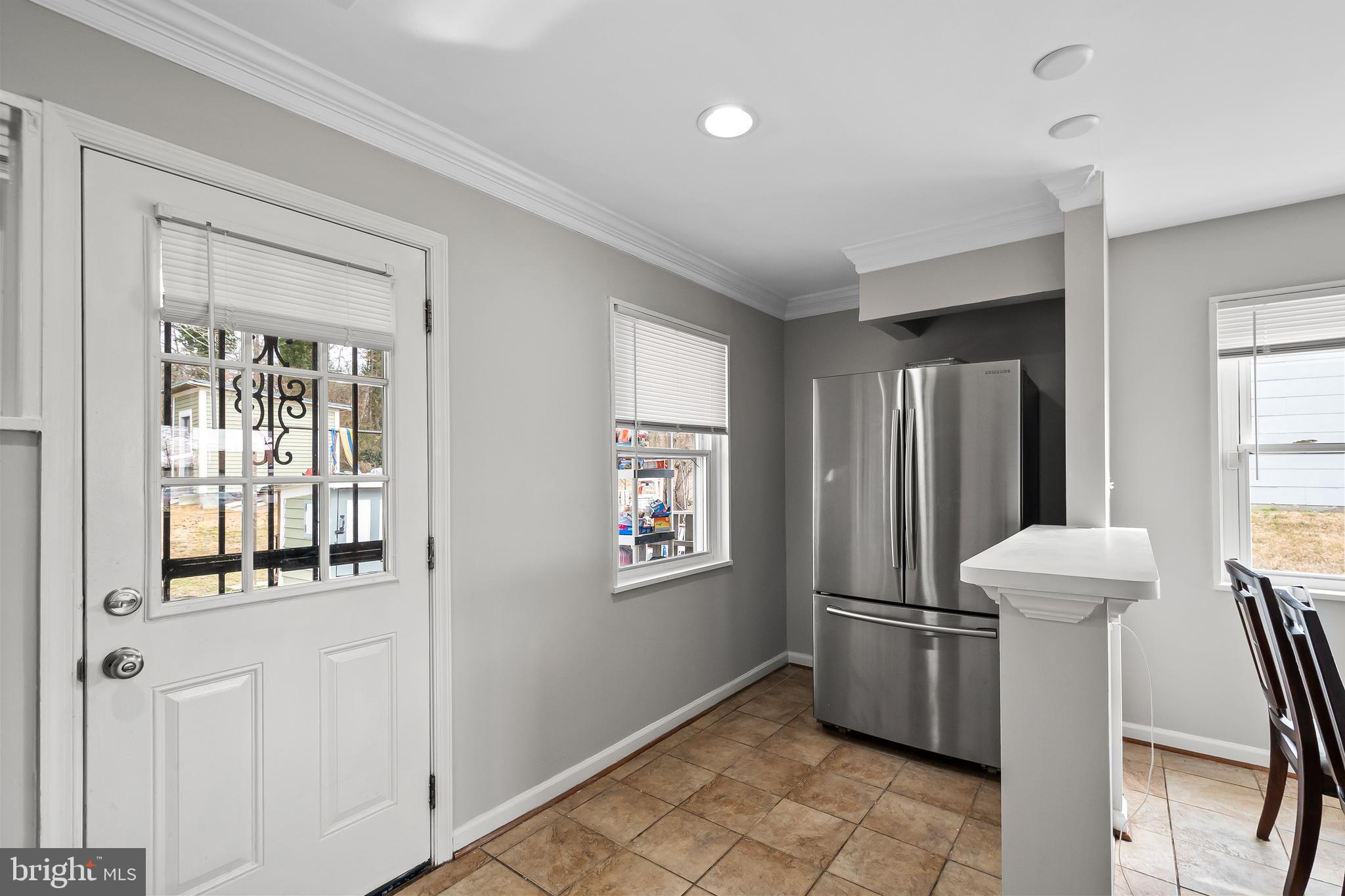 1204 Lindsay Road Oxon Hill, MD 20745 - Photo 12 of 28 a view of a hallway with windows and chandelier
