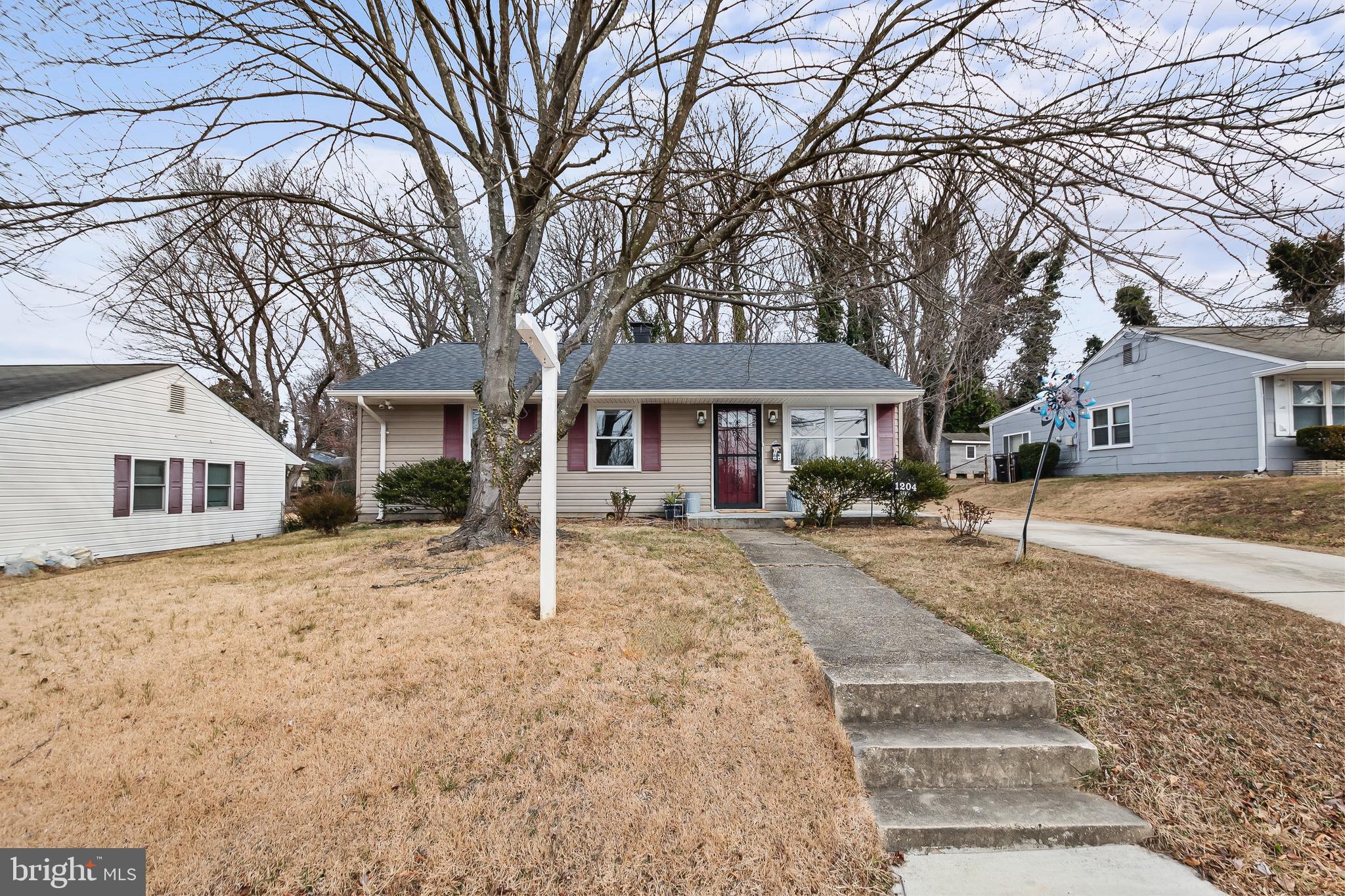 1204 Lindsay Road Oxon Hill, MD 20745 - Photo 2 of 28 a front view of a house with a yard and garage