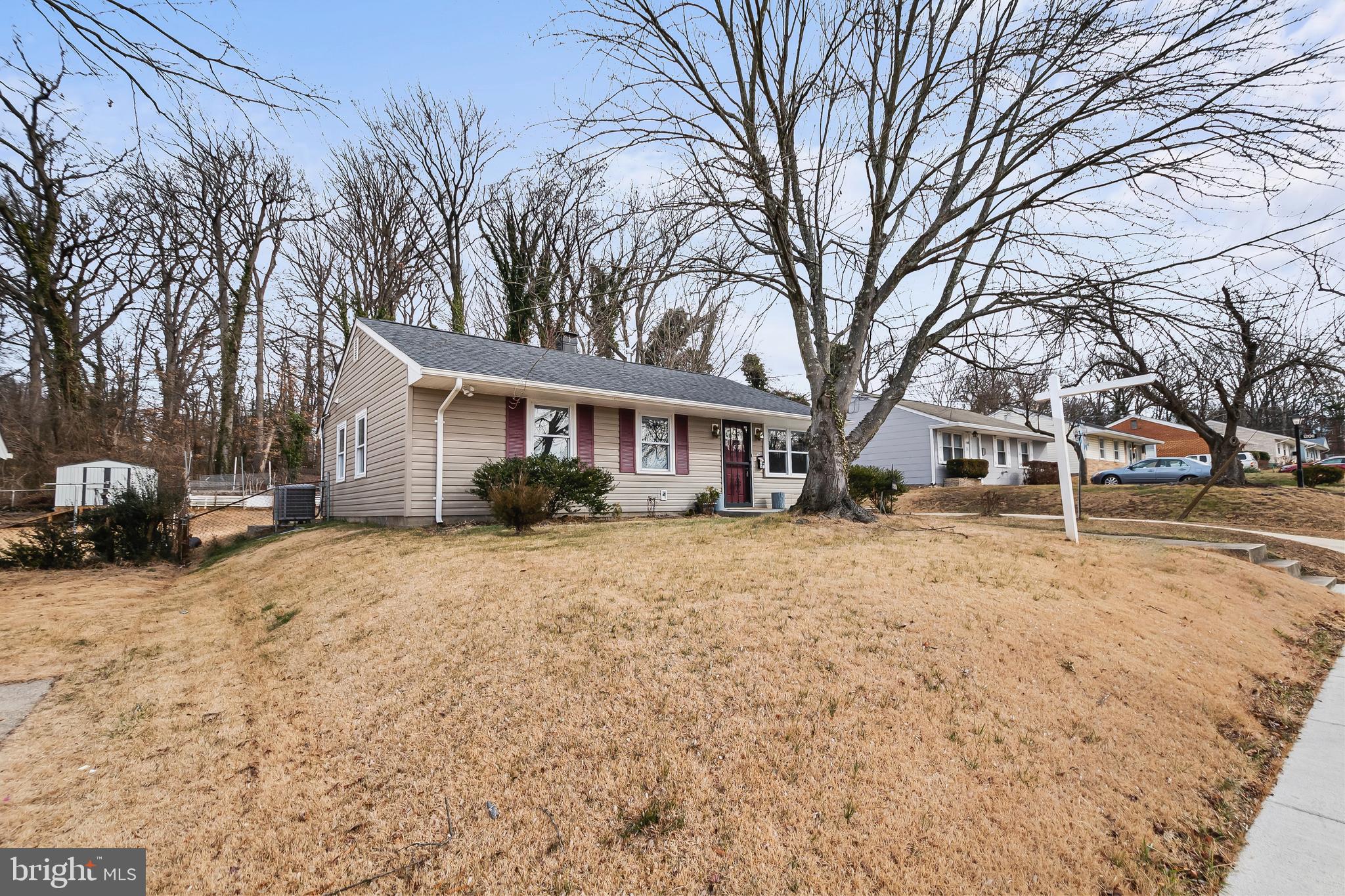 1204 Lindsay Road Oxon Hill, MD 20745 - Photo 3 of 28 a front view of a house with a yard covered in snow