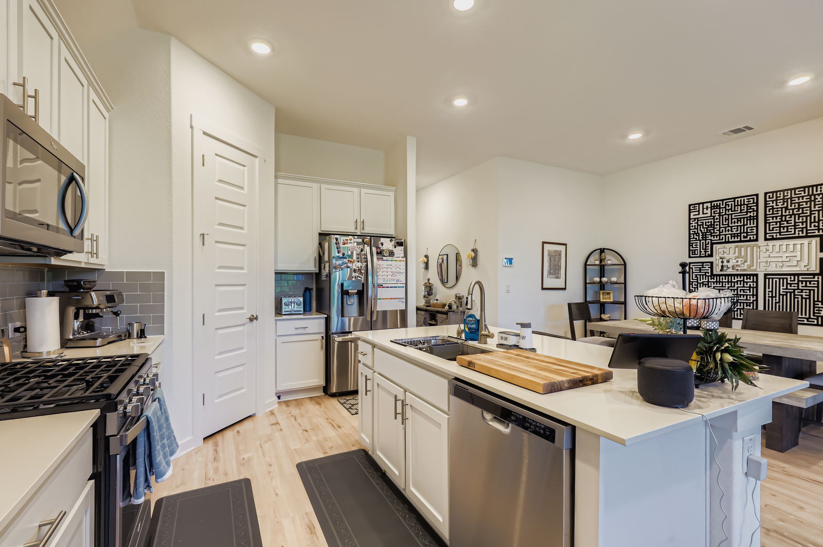 1909 Ruger Pass Leander, TX 78641 - Photo 8 of 31 Kitchen featuring appliances with stainless steel finishes, light countertops, decorative backsplash, recessed lighting, and white cabinets
