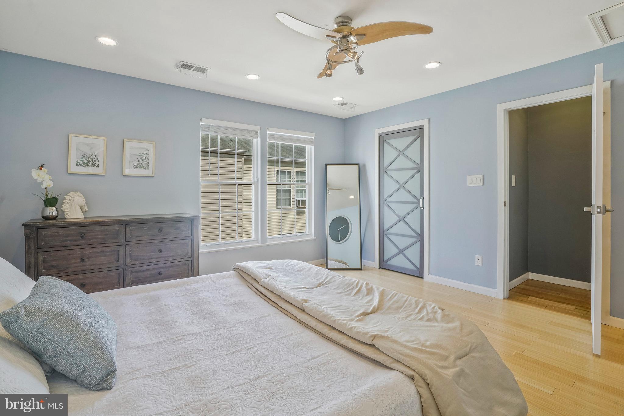 2181 Shirlington Road Arlington, VA 22206 - Photo 26 of 48 a bedroom with a large bed and a dresser