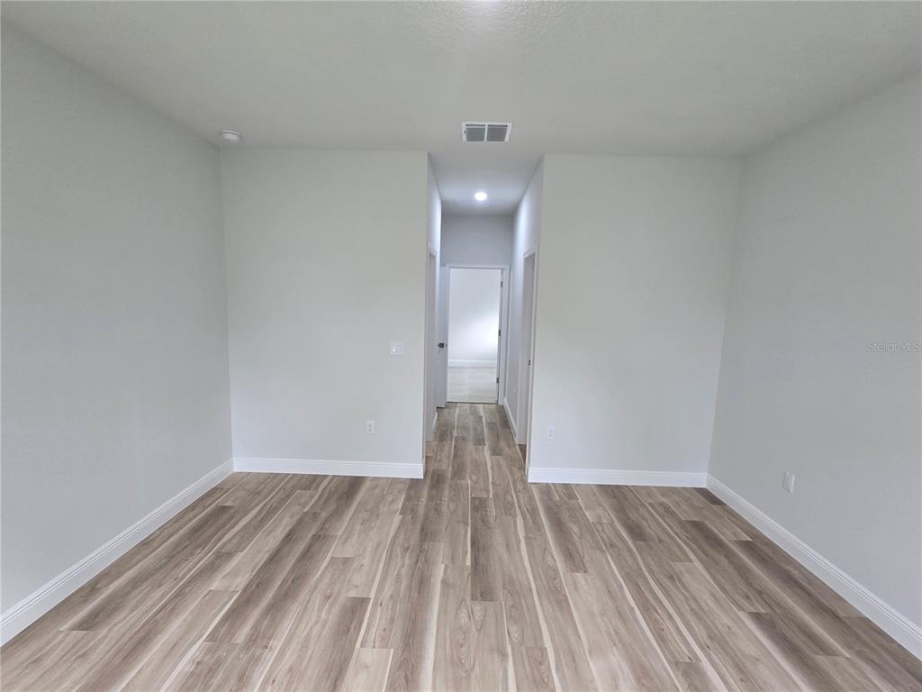 2717 Southwest 140th Loop Ocala, FL 34473 - Photo 16 of 40 a view of empty room with wooden floor