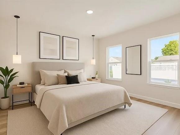 2717 Southwest 140th Loop Ocala, FL 34473 - Photo 17 of 40 a bedroom with a large bed and a window