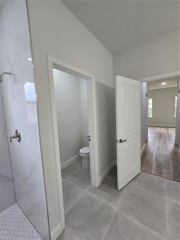 2717 Southwest 140th Loop Ocala, FL 34473 - Photo 22 of 40 a view of a bathroom with a sink and a toilet